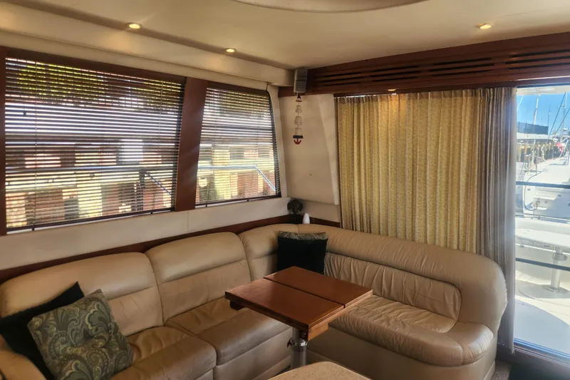 Slide: The Image of Luxurious interior of a 1998 Carver 530 Voyager Pilothouse with leather seating and wooden accents. - 32