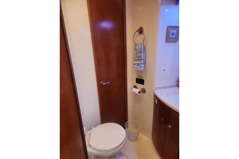Slide: The Image of Bathroom interior of 1998 Carver 530 Voyager Pilothouse yacht, featuring wooden cabinetry. - 34