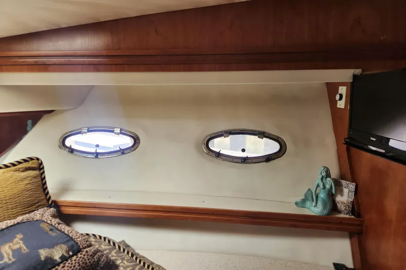 Slide: The Image of Interior of 1998 Carver 530 Voyager Pilothouse with portholes, TV, and mermaid decor. - 37