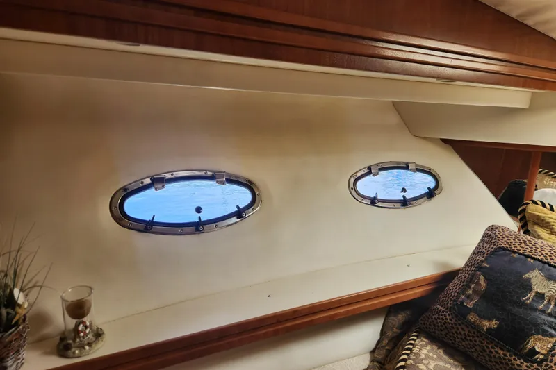 Slide: The Image of Interior of 1998 Carver 530 Voyager Pilothouse with oval windows and decorative pillows. - 38