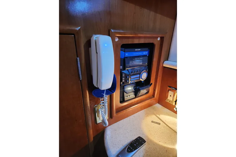Slide: The Image of 1998 Carver 530 Voyager Pilothouse interior with phone and stereo system. - 39