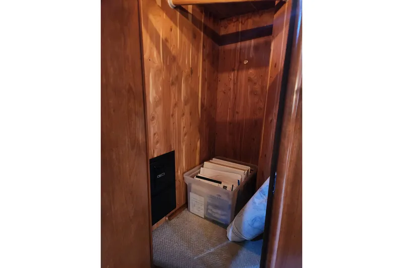 Slide: The Image of Wooden closet interior on 1998 Carver 530 Voyager Pilothouse with storage box and carpeted floor. - 41
