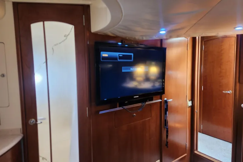 Slide: The Image of Interior of 1998 Carver 530 Voyager Pilothouse with mounted TV and wooden cabinetry. - 44