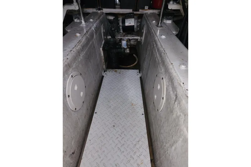 Slide: The Image of Engine room of 1998 Carver 530 Voyager Pilothouse with metal flooring and machinery. - 45