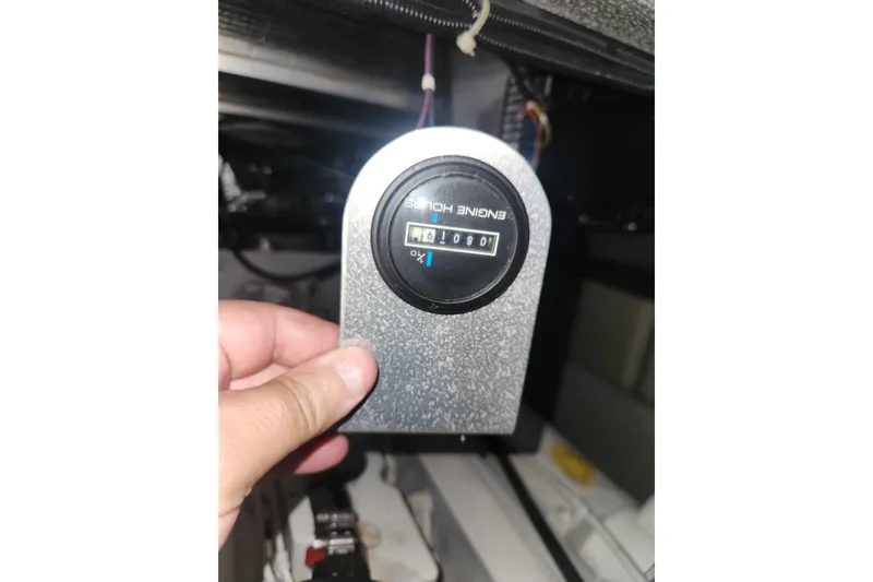 Slide: The Image of Hand holding engine hour meter in Carver 530 Voyager Pilothouse, 1998 model. - 47