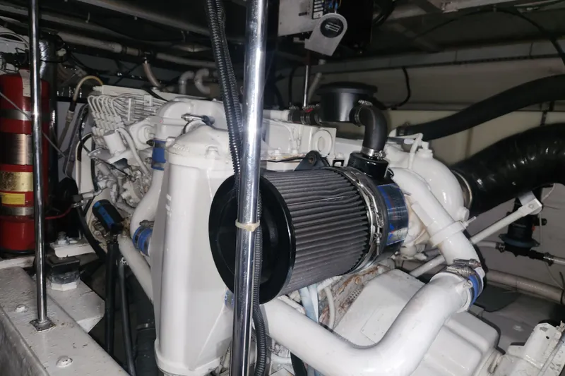 Slide: The Image of Engine room of a 1998 Carver 530 Voyager Pilothouse with visible components and fire extinguisher. - 49