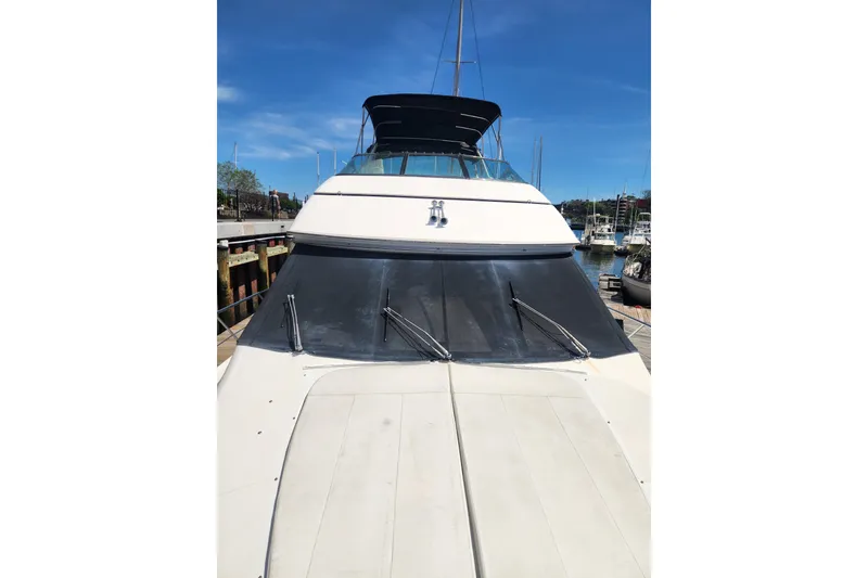 Slide: The Image of 1998 Carver 530 Voyager Pilothouse yacht docked under clear blue sky. - 6