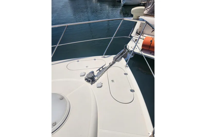 Slide: The Image of Bow of 1998 Carver 530 Voyager Pilothouse yacht with anchor chain and railing. - 8