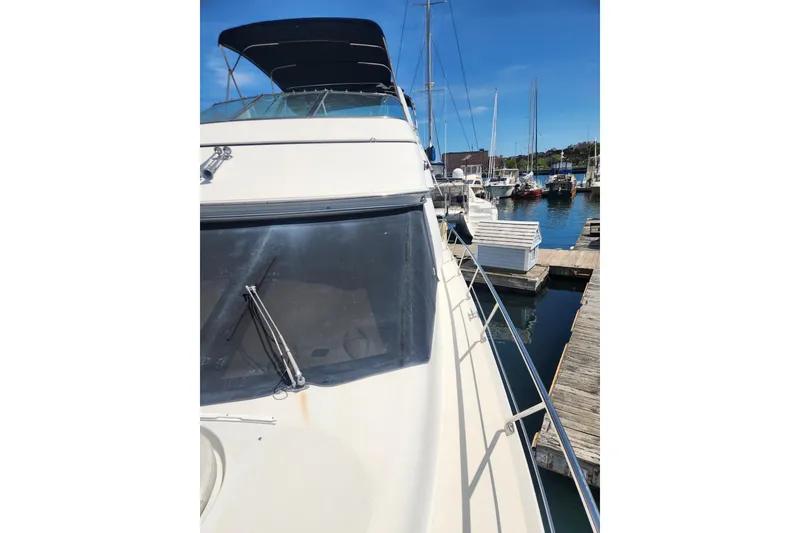 Slide: The Image of 1998 Carver 530 Voyager Pilothouse yacht docked at marina under clear blue sky. - 9