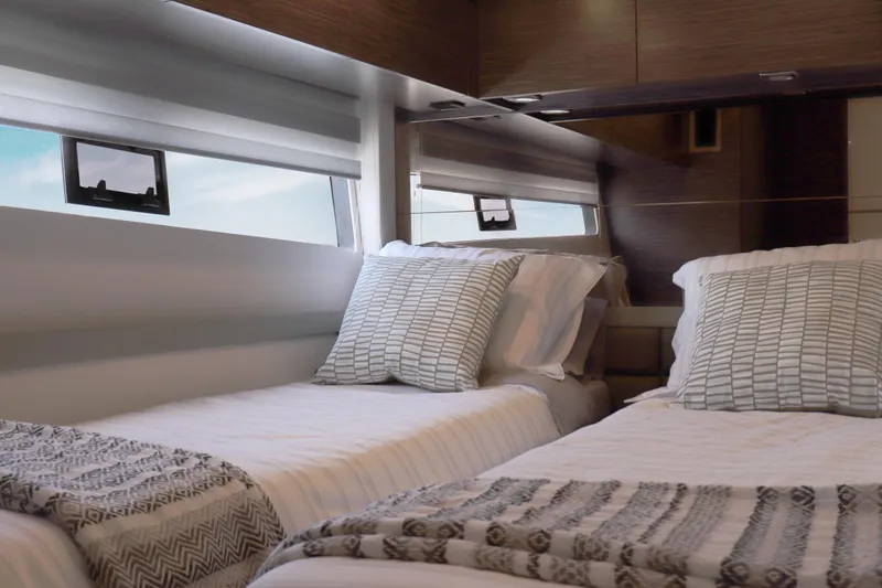 Slide: The Image of Luxurious twin cabin interior of 2026 Cobrey 52 HT yacht with modern decor. - 13