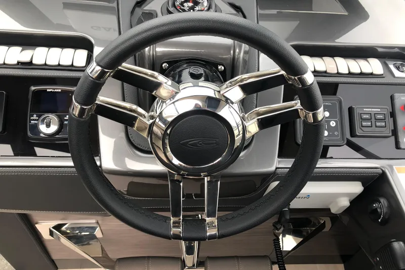 Slide: The Image of Steering wheel of 2026 Cobrey 52 HT yacht, featuring modern controls and sleek design. - 5