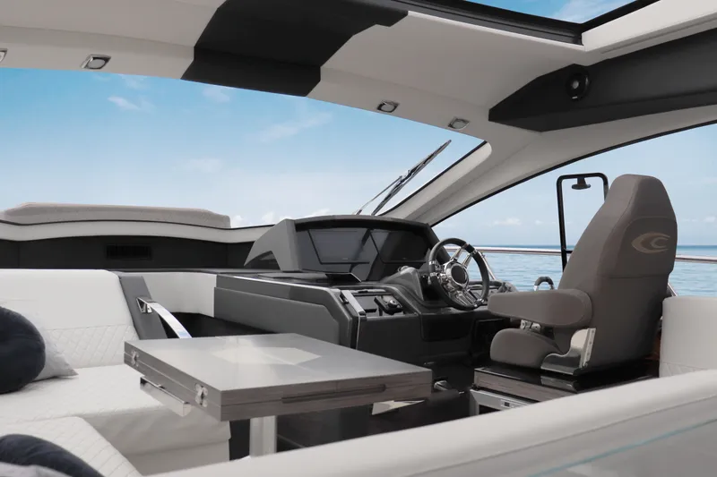 Slide: The Image of Interior of 2026 Cobrey 52 HT yacht, featuring modern helm and luxurious seating. - 6