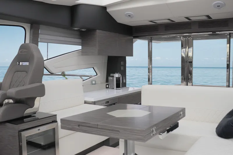 Slide: The Image of Luxurious interior of 2026 Cobrey 52 HT yacht with ocean view through large windows. - 7