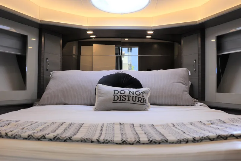 Slide: The Image of Luxurious bedroom interior of 2026 Cobrey 52 HT yacht with "Do Not Disturb" pillow. - 9