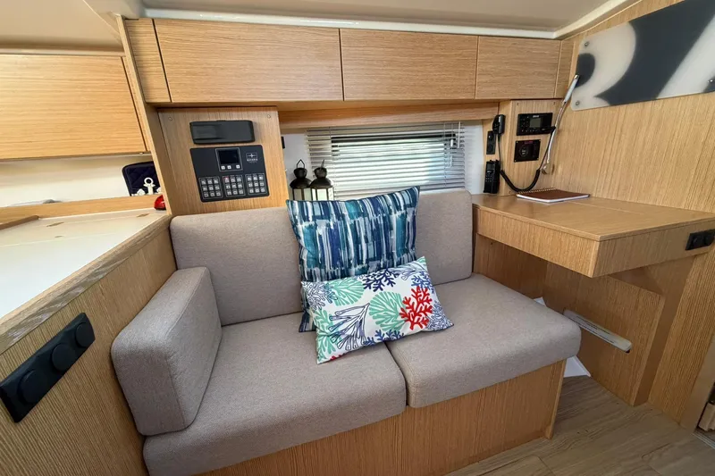 Slide: The Image of Modern Bavaria C38 yacht interior with cozy seating and nautical-themed cushions, 2022 model. - 3