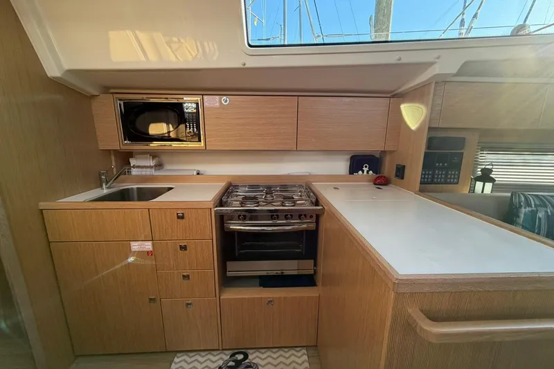 Slide: The Image of Modern kitchen in 2022 Bavaria C38 yacht with stove, sink, and microwave. - 4