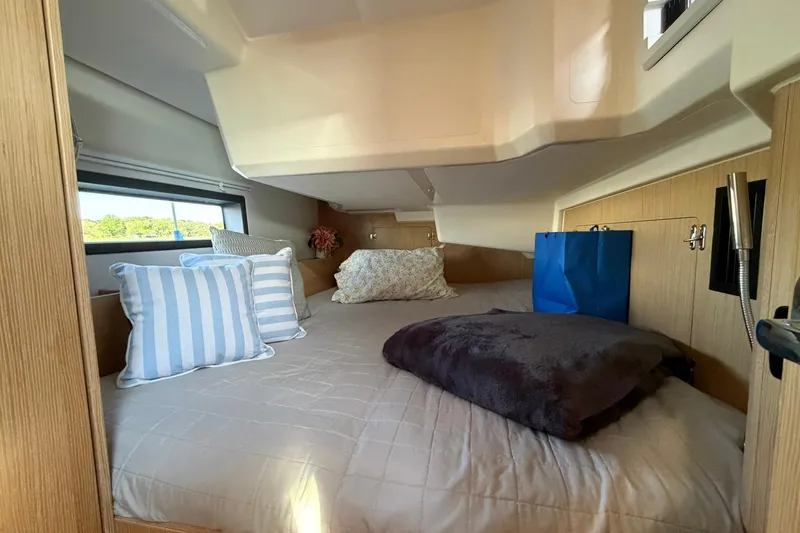 Slide: The Image of Cozy cabin interior of 2022 Bavaria C38 yacht with plush bedding and decorative pillows. - 6