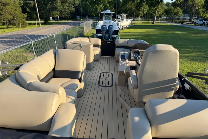 Slide: The Image of 2017 Manitou 25 Legacy pontoon boat with beige seating and spacious deck. - 22