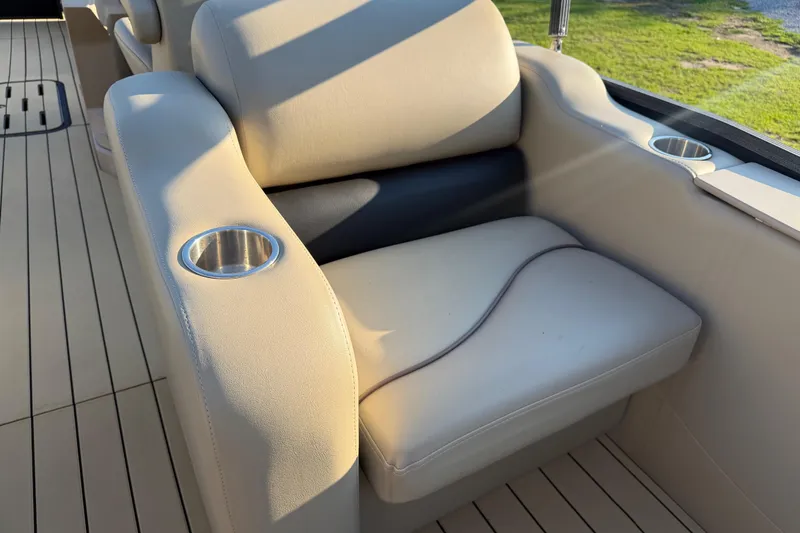 Slide: The Image of Luxurious seating on 2017 Manitou 25 Legacy boat with cup holders and elegant design. - 23