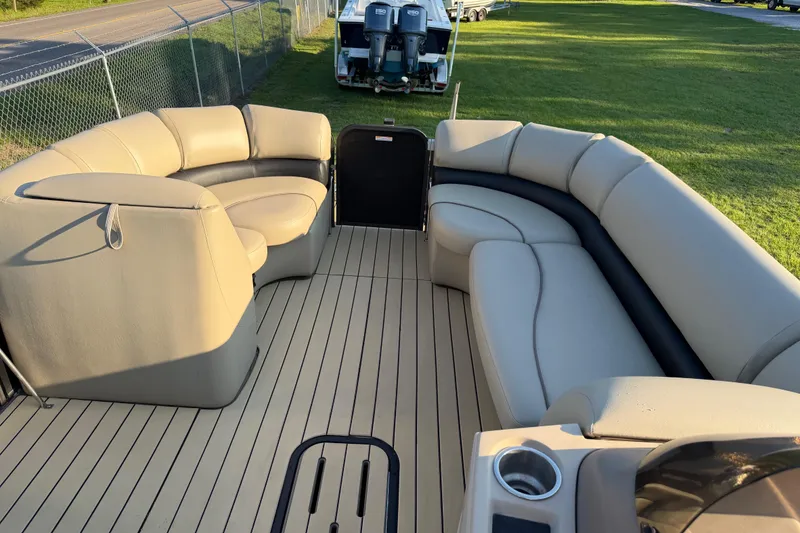 Slide: The Image of 2017 Manitou 25 Legacy pontoon boat with spacious seating and modern interior design. - 25