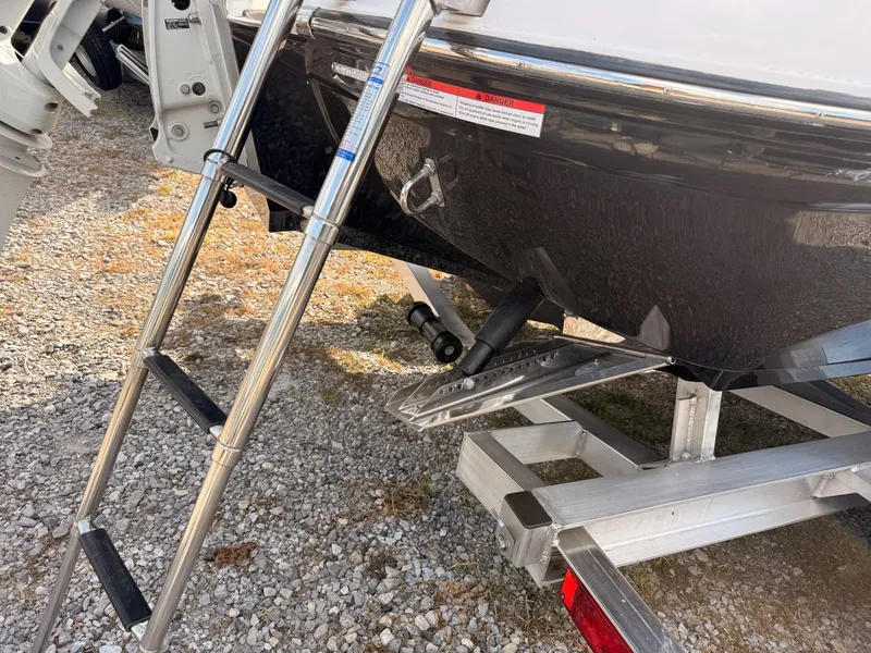 Slide: The Image of Stingray 23 OSX 2026 boat on trailer with ladder. - 19