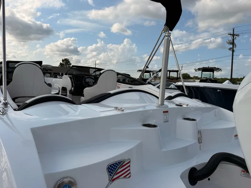 Slide: The Image of 2026 Stingray 23 OSX boat with modern seating and American flag. - 21