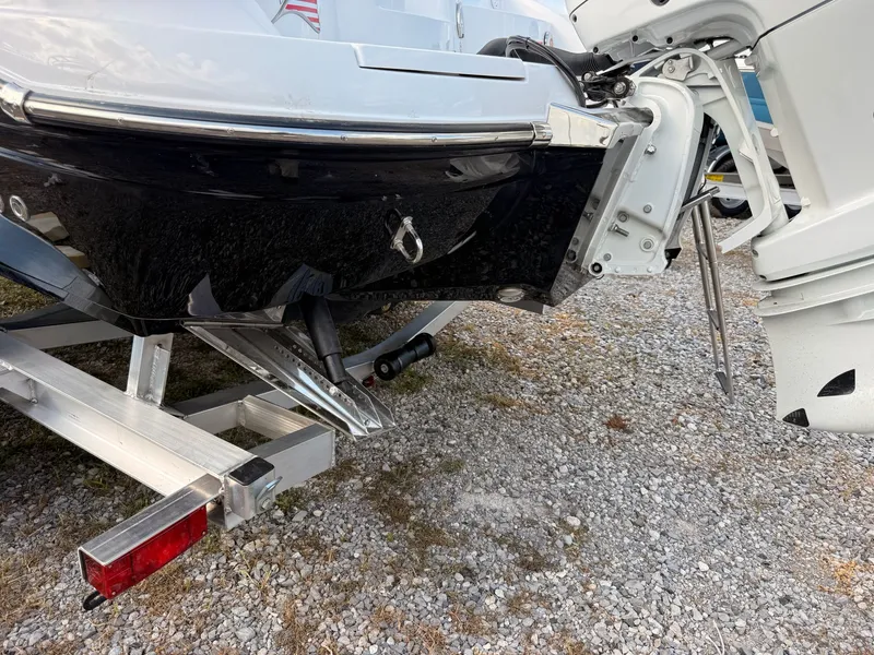 Slide: The Image of Rear view of a 2026 Stingray 23 OSX boat on a trailer. - 22