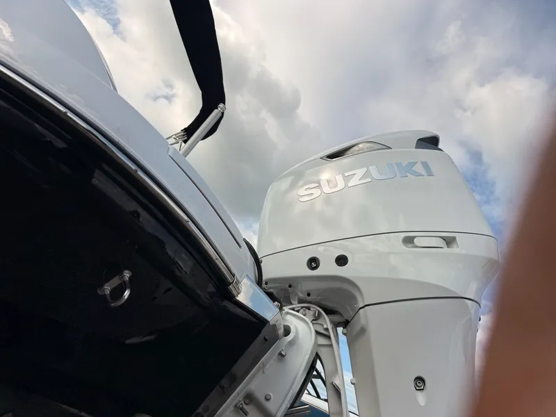 Slide: The Image of Suzuki outboard motor on a 2026 Stingray 23 OSX boat. - 23