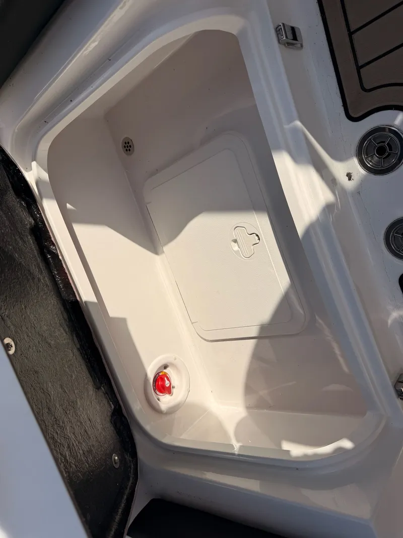 Slide: The Image of Interior of Stingray 23 OSX 2026 with storage compartment and cover. - 25