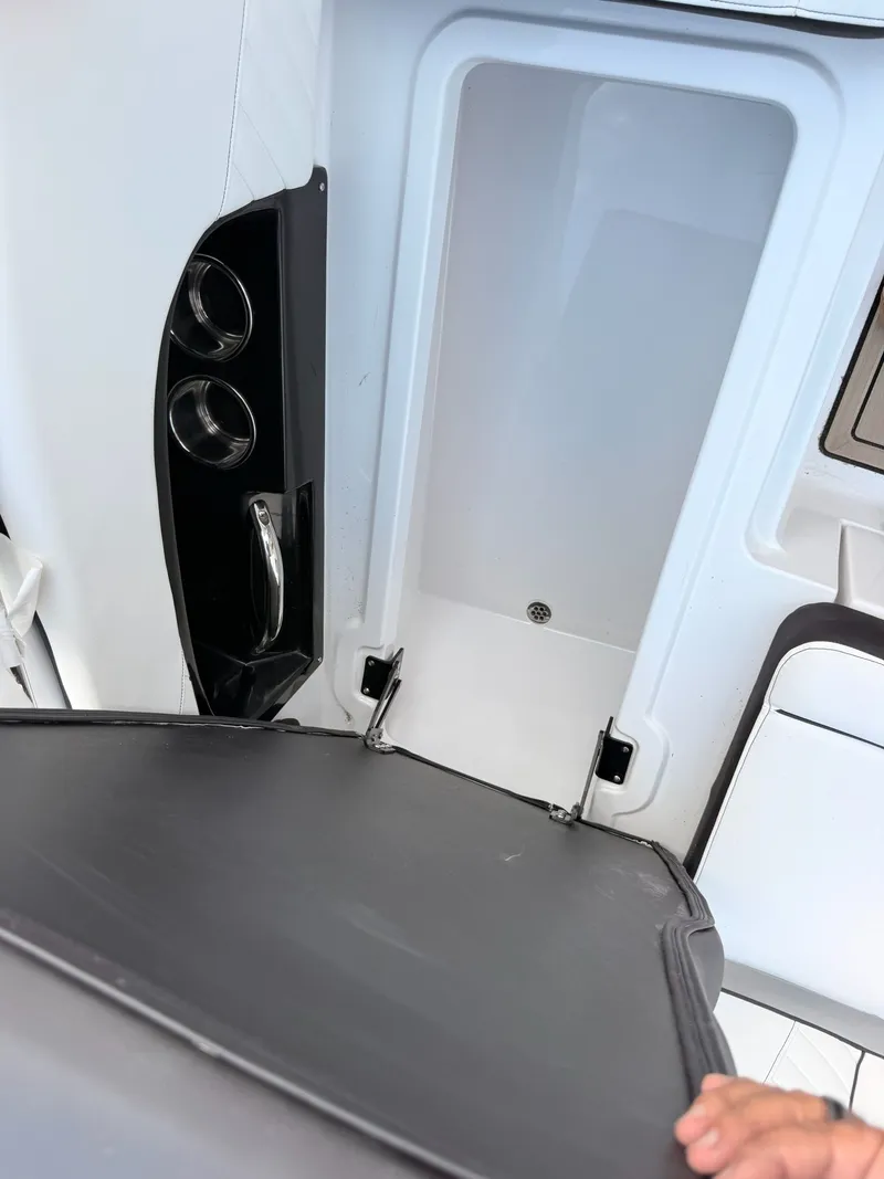 Slide: The Image of Interior of 2026 Stingray 23 OSX with storage and cup holders. - 27