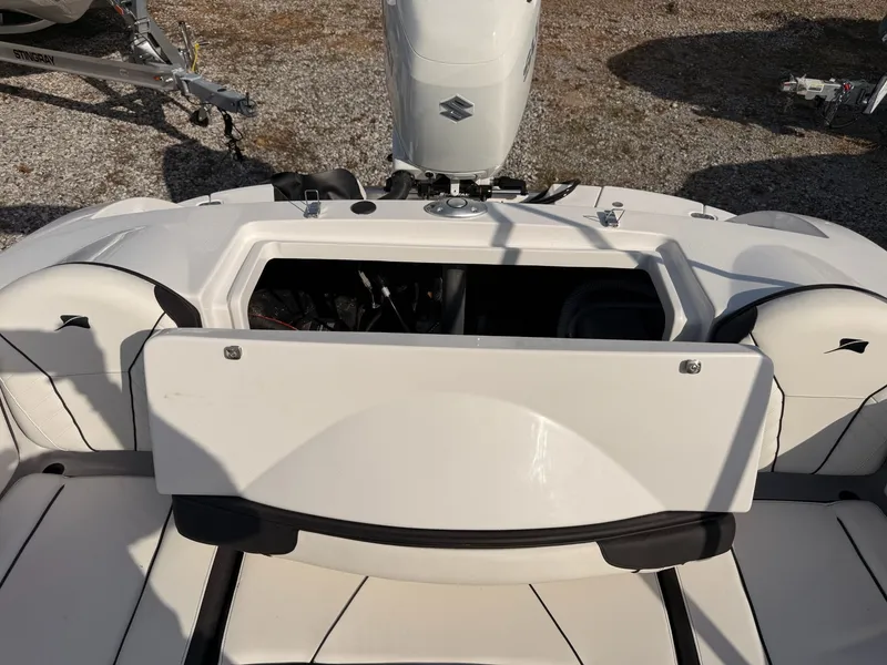 Slide: The Image of Stingray 23 OSX 2026 boat with open storage compartment and engine. - 29