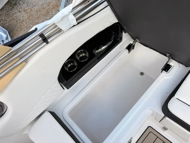 Slide: The Image of Interior of 2026 Stingray 23 OSX with cup holders. - 30