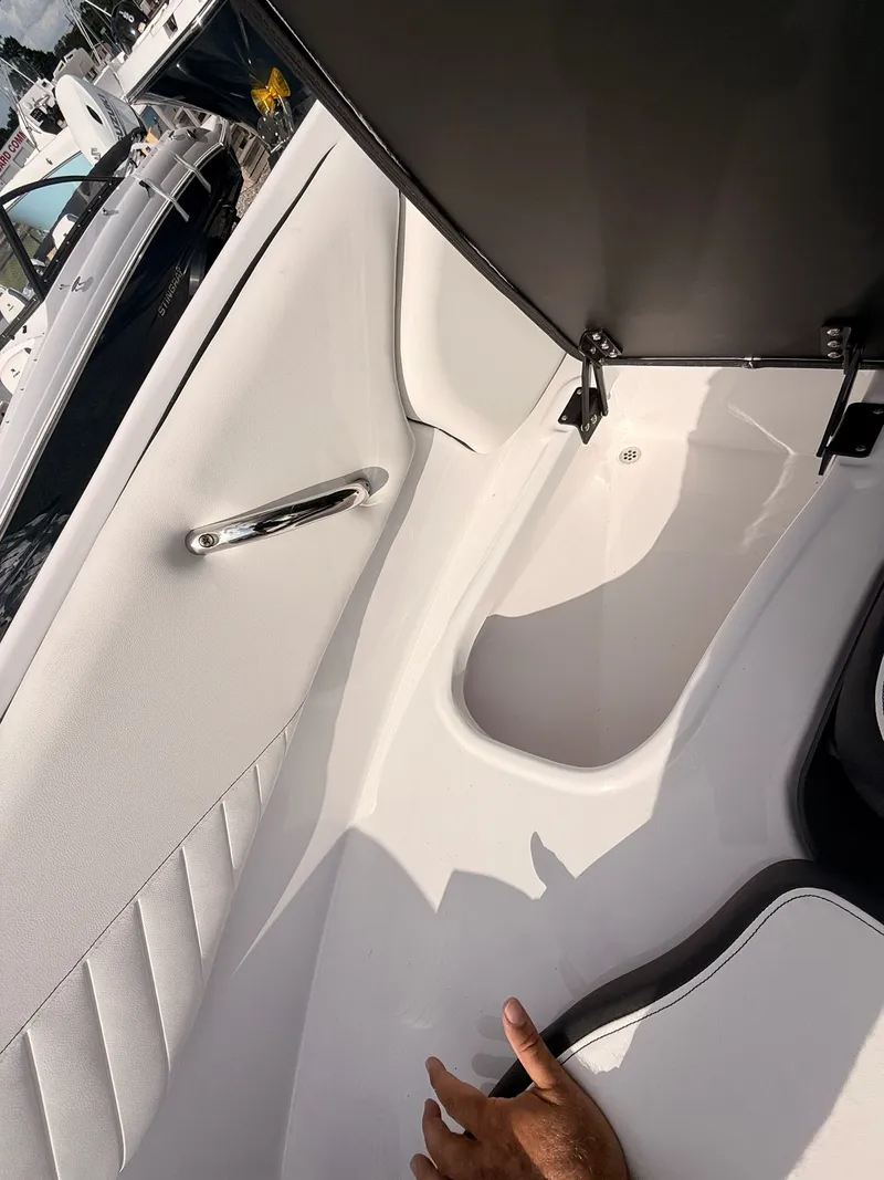 Slide: The Image of Interior of 2026 Stingray 23 OSX with storage compartment. - 39