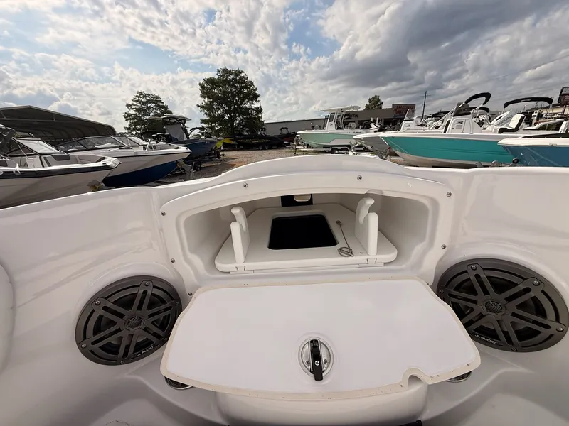 Slide: The Image of Stingray 23 OSX 2026 boat with storage and speakers at the marina. - 46