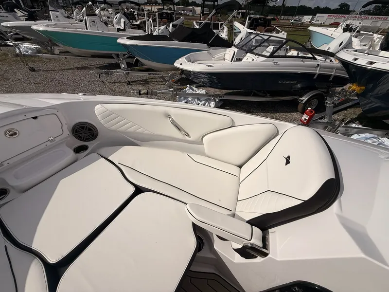 Slide: The Image of 2026 Stingray 23 OSX boat with luxurious white interior seating. - 47