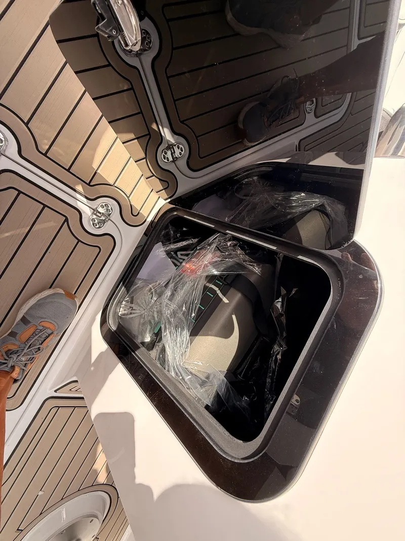Slide: The Image of Stingray 23 OSX 2026 boat with open storage compartment on deck. - 48