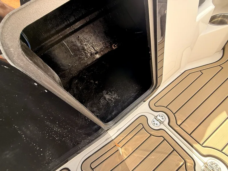 Slide: The Image of Stingray 23 OSX 2026 boat hatch with wooden flooring. - 49