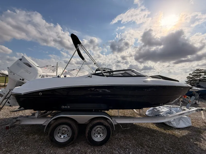 Slide: The Image of 2026 Stingray 23 OSX boat on trailer at sunset. - 8