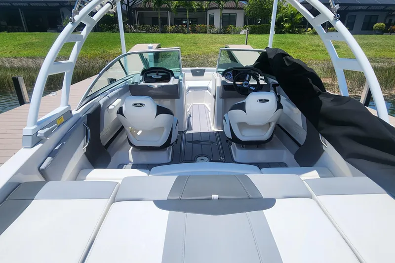 Slide: The Image of 2022 Chaparral 21 SSi OB boat interior with sleek seating and modern dashboard design. - 14