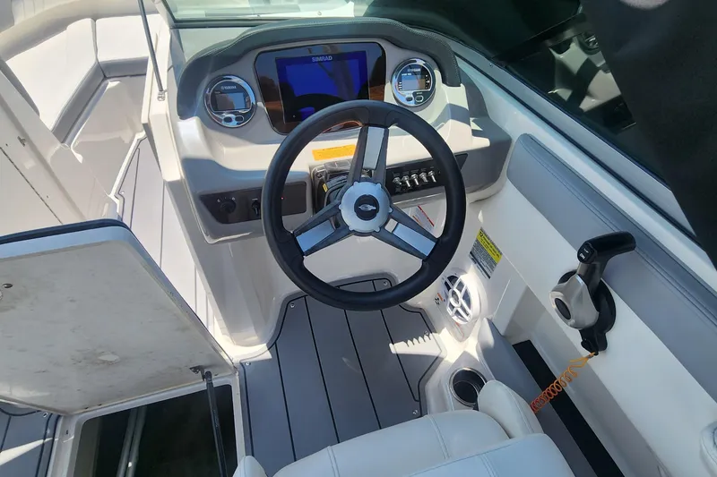 Slide: The Image of 2022 Chaparral 21 SSi OB boat cockpit with steering wheel and control panel. - 19