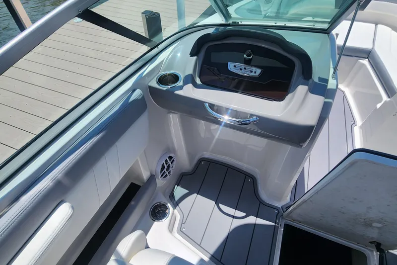 Slide: The Image of 2022 Chaparral 21 SSi OB boat interior with sleek seating and storage compartments. - 20