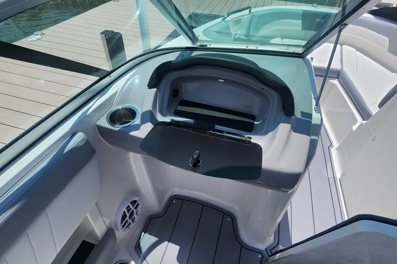 Slide: The Image of 2022 Chaparral 21 SSi OB boat interior with seating and storage compartment. - 21