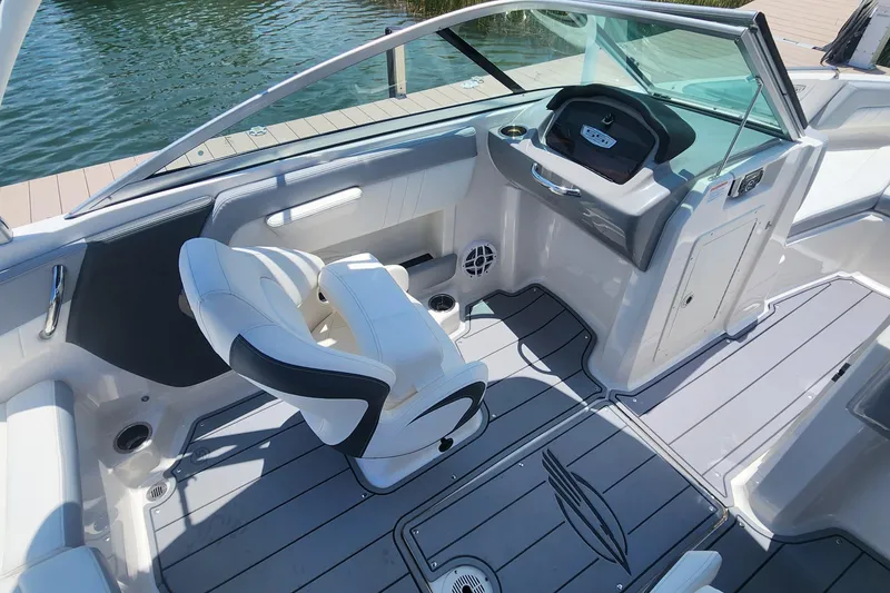 Slide: The Image of 2022 Chaparral 21 SSi OB boat interior with sleek seating and modern dashboard design. - 22