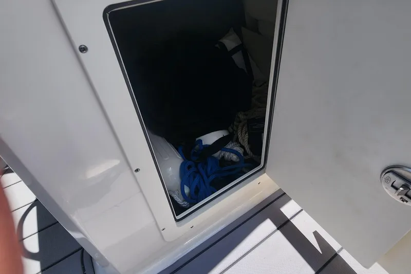 Slide: The Image of Storage compartment on a 2022 Chaparral 21 SSi OB boat, containing ropes and gear. - 27