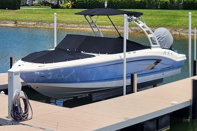 Slide: The Image of 2022 Chaparral 21 SSi OB boat docked on a sunny day, covered and ready for use. - 3