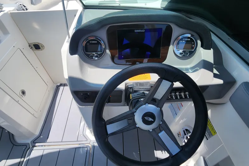 Slide: The Image of 2022 Chaparral 21 SSi OB boat dashboard with steering wheel and digital display. - 30