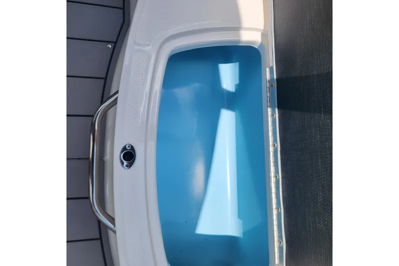 Slide: The Image of 2022 Chaparral 21 SSi OB boat interior with blue storage compartment. - 31