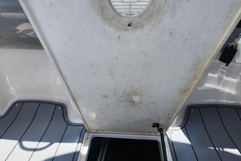 Slide: The Image of 2022 Chaparral 21 SSi OB boat interior showing storage compartment and flooring details. - 45