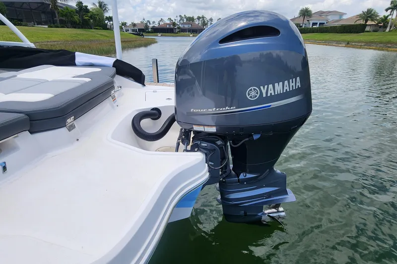 Slide: The Image of 2022 Chaparral 21 SSi OB with Yamaha outboard motor on a calm lake. - 48