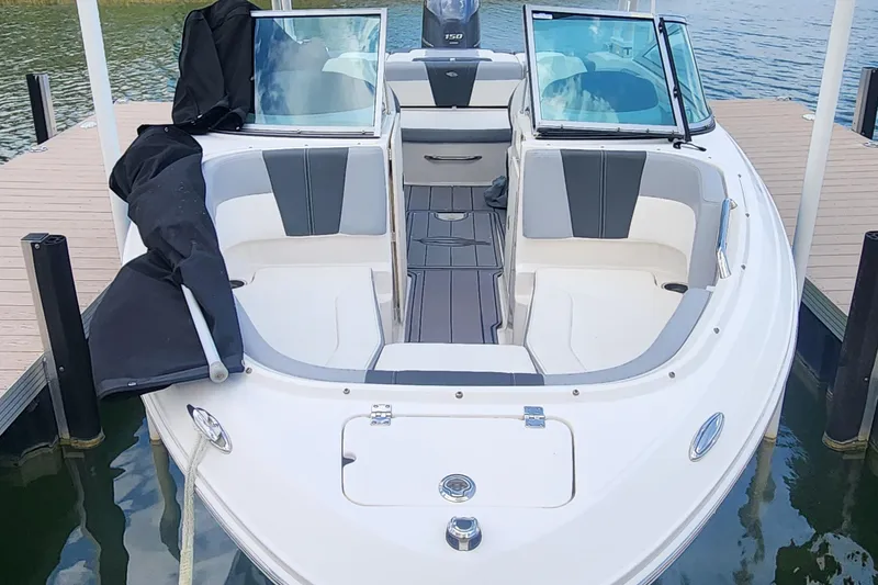 Slide: The Image of 2022 Chaparral 21 SSi OB boat docked, featuring spacious seating and sleek design. - 52